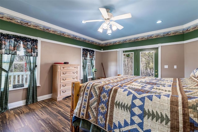 bedroom featuring visible vents, ornamental molding, wood finished floors, baseboards, and ceiling fan