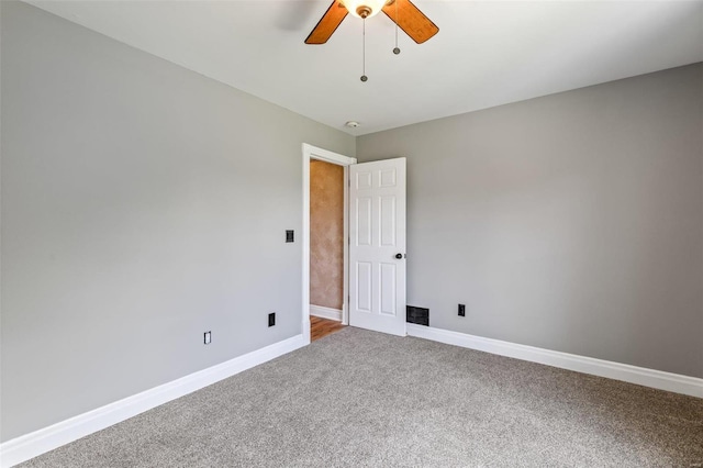 spare room featuring a ceiling fan, baseboards, and carpet floors