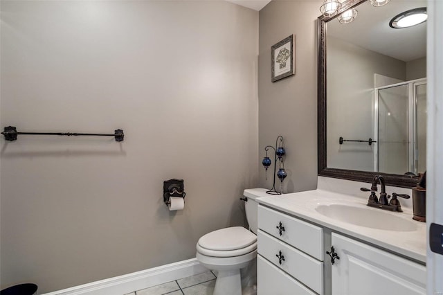 bathroom featuring vanity, baseboards, a shower stall, tile patterned floors, and toilet