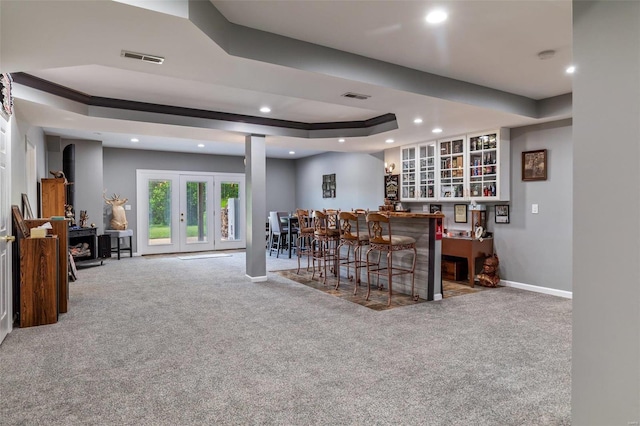 bar featuring carpet flooring, baseboards, a raised ceiling, and visible vents