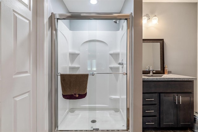 full bath featuring vanity and a shower stall
