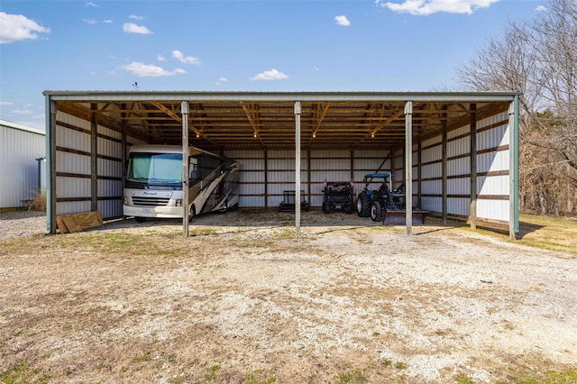 view of parking with a carport and a pole building