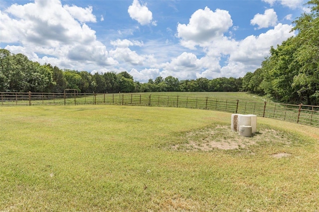 view of yard with a rural view and fence