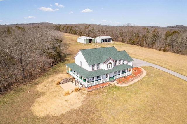 birds eye view of property with a wooded view