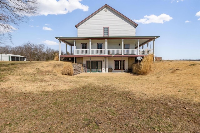 back of house with a lawn and french doors