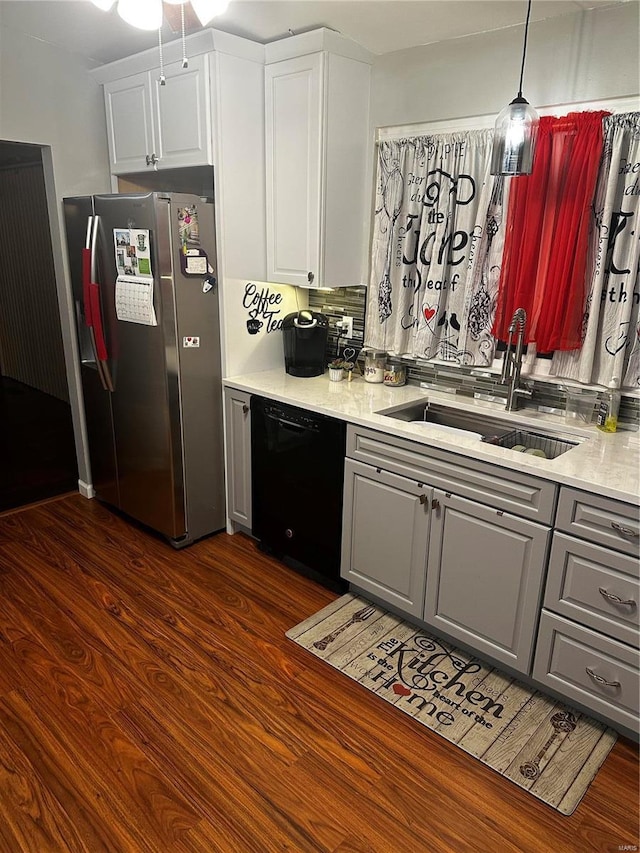 kitchen with a sink, dishwasher, gray cabinetry, and freestanding refrigerator