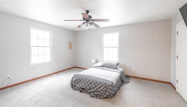 bedroom with carpet floors, visible vents, ceiling fan, and baseboards