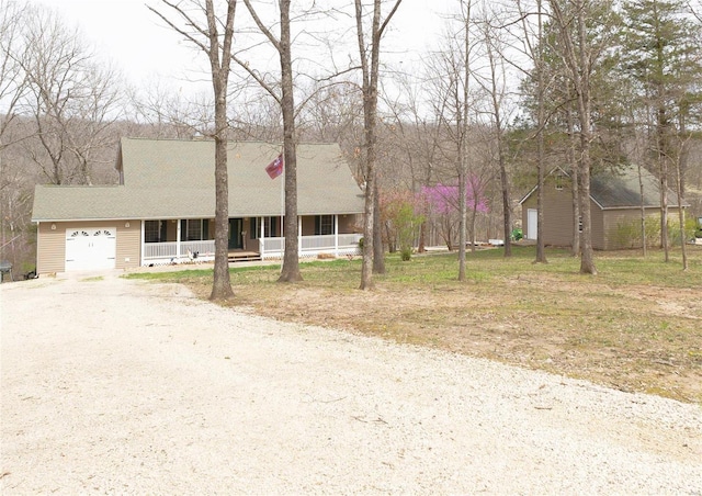 view of front of property with driveway, covered porch, and a garage