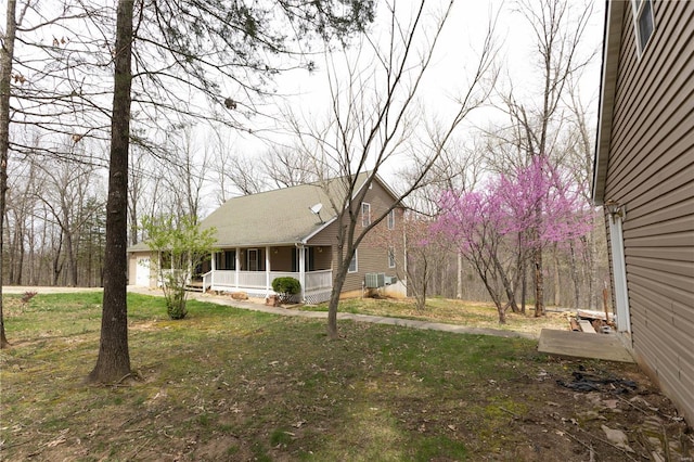 view of yard featuring central air condition unit and a porch