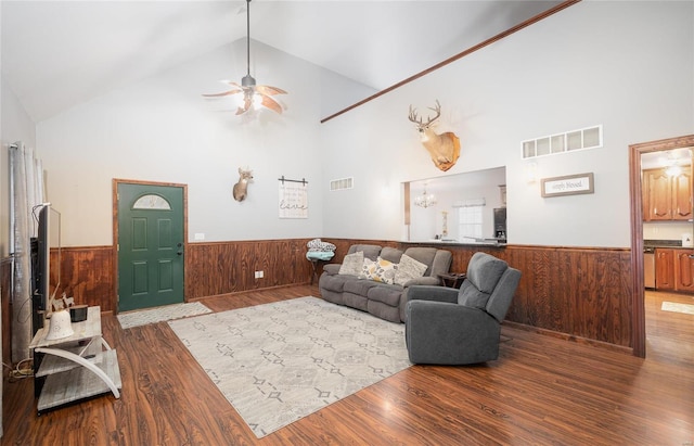 living room featuring wood finished floors, wainscoting, and visible vents