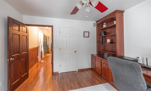 office area featuring dark wood-style floors, visible vents, baseboards, and ceiling fan