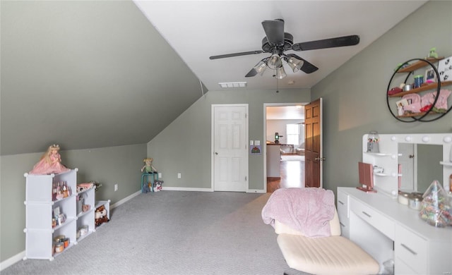 interior space featuring ceiling fan, vaulted ceiling, visible vents, carpet floors, and baseboards
