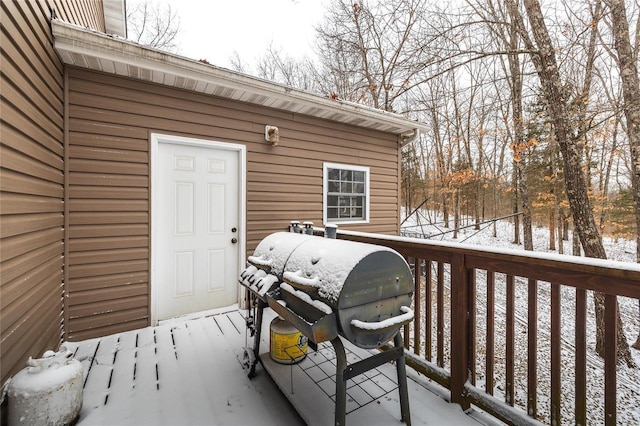 snow covered deck featuring a grill