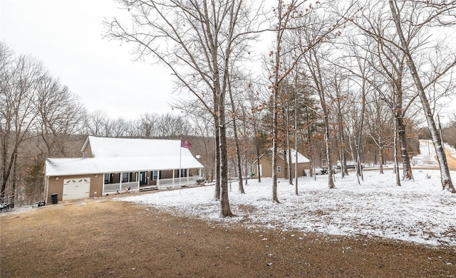 view of front of house with covered porch and a garage