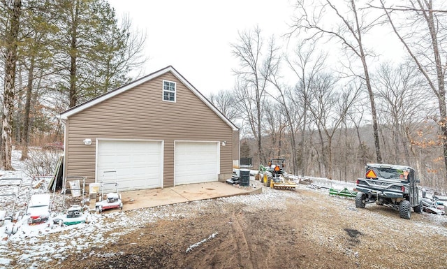 detached garage featuring a wooded view