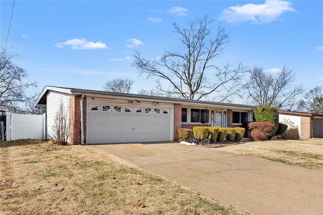 ranch-style home with brick siding, an attached garage, a front yard, fence, and driveway