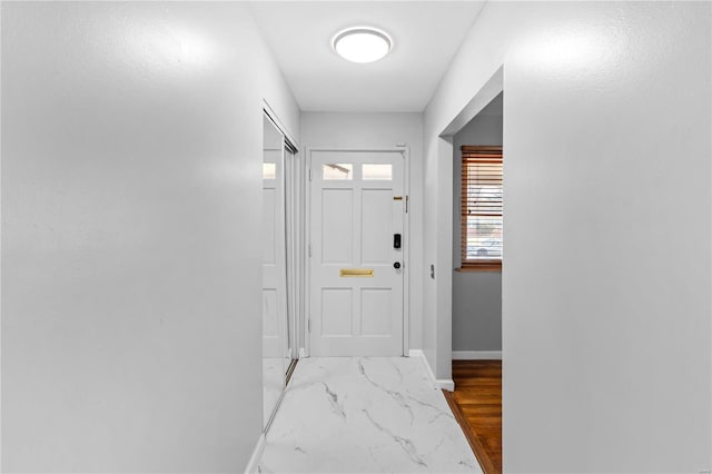 doorway to outside with baseboards