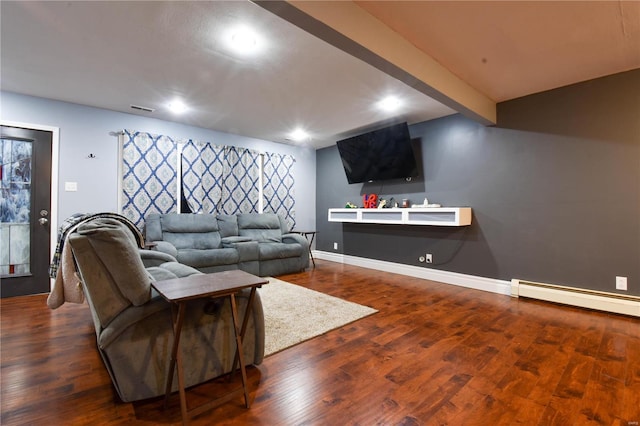 living area with visible vents, beam ceiling, a baseboard heating unit, wood finished floors, and baseboards