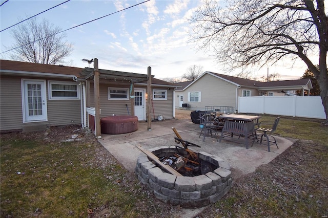 back of house with a patio, a fire pit, a hot tub, and fence