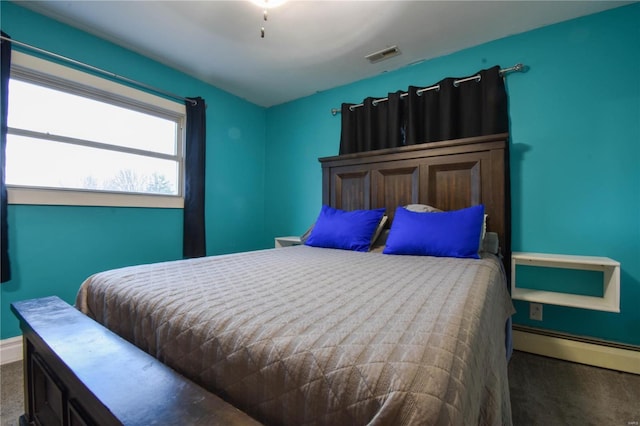 carpeted bedroom featuring baseboards, visible vents, and baseboard heating