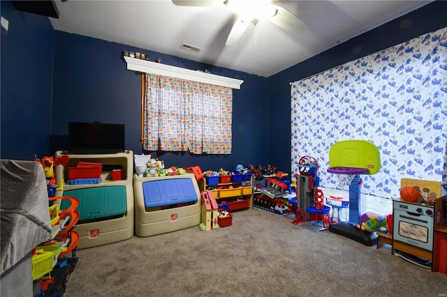 playroom featuring visible vents, carpet, and ceiling fan