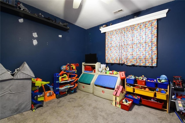 game room with visible vents, a ceiling fan, and carpet flooring