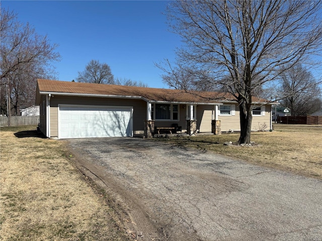 ranch-style house with driveway, an attached garage, a front yard, and fence