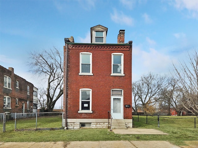 view of front of property with entry steps, a chimney, a front lawn, and brick siding