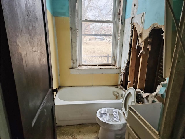 full bath featuring vanity, toilet, and a bath