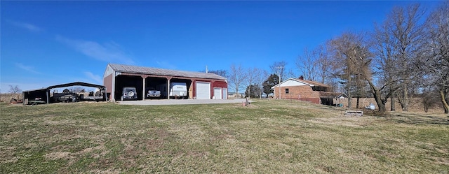 rear view of property with an outbuilding, a lawn, and a garage