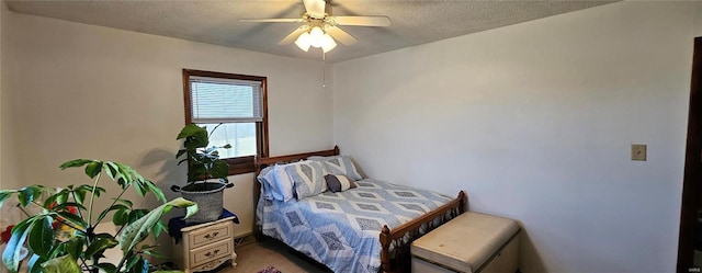 carpeted bedroom featuring a textured ceiling and a ceiling fan