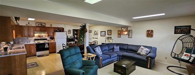 living room with baseboards and light colored carpet