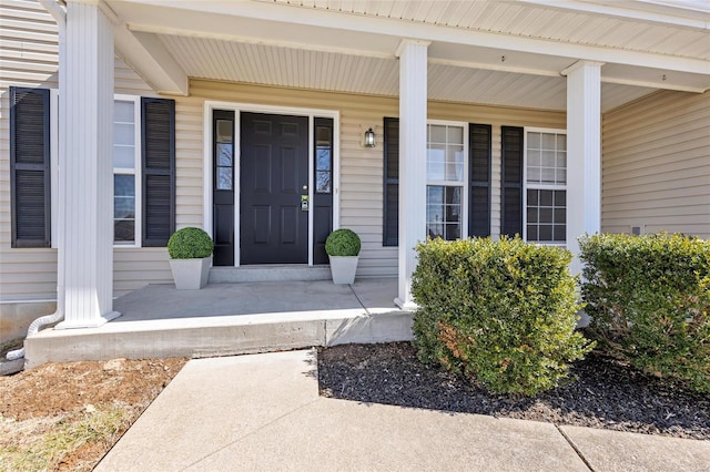 view of exterior entry with a porch