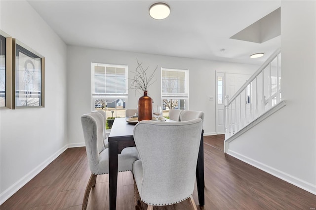 dining space with dark wood-style floors, stairs, and baseboards