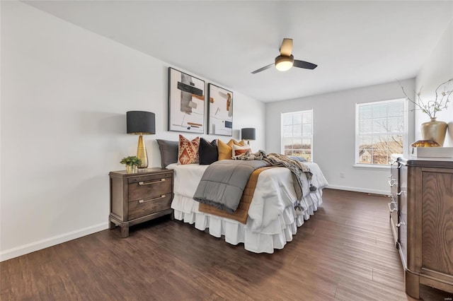 bedroom with baseboards, dark wood finished floors, and a ceiling fan