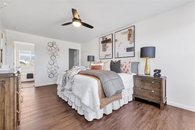 bedroom with dark wood-style floors, baseboards, and a ceiling fan