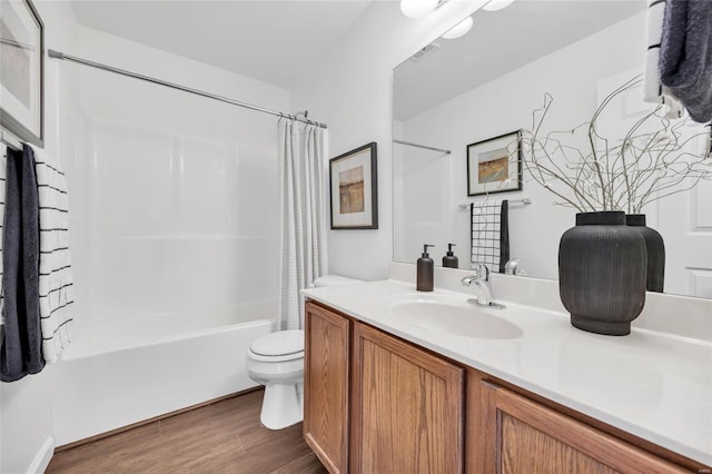 full bathroom with visible vents, shower / bathtub combination with curtain, toilet, vanity, and wood finished floors