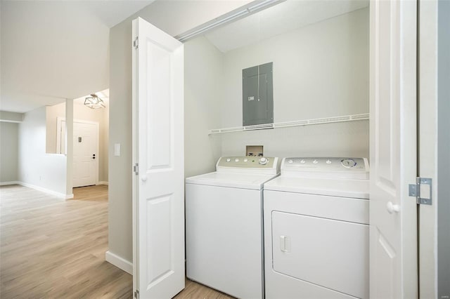 laundry area featuring electric panel, laundry area, independent washer and dryer, and light wood-style floors