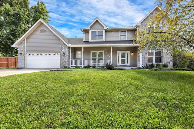 traditional home with concrete driveway, a porch, fence, a front lawn, and brick siding