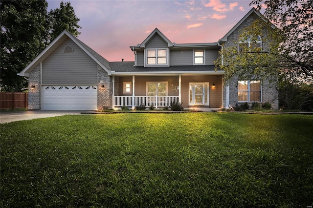 traditional-style home featuring covered porch, brick siding, a yard, and concrete driveway