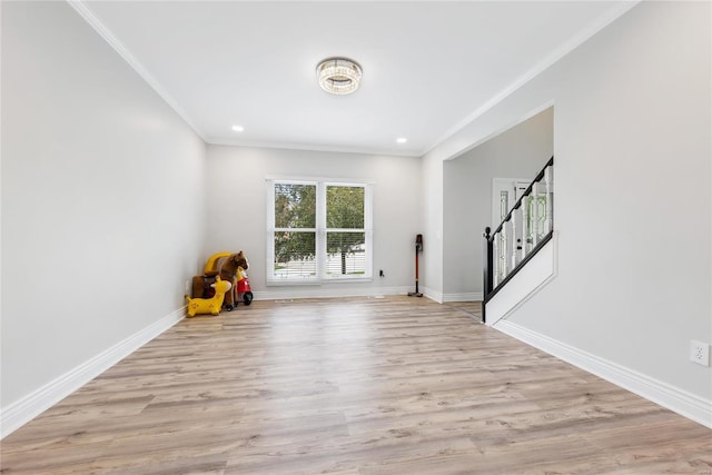 interior space with ornamental molding, stairway, wood finished floors, and baseboards