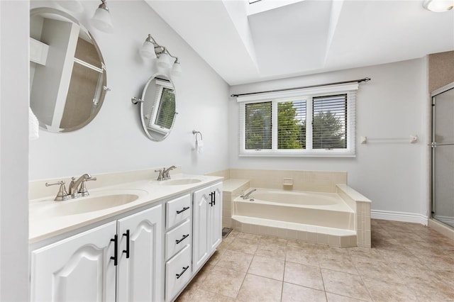 full bathroom with a stall shower, a garden tub, a sink, and tile patterned floors