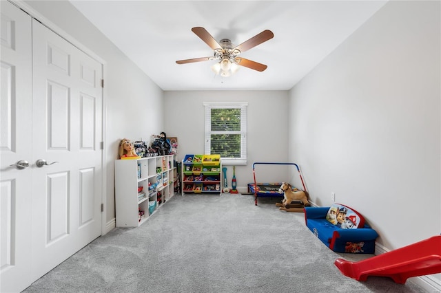 game room featuring carpet flooring, ceiling fan, and baseboards