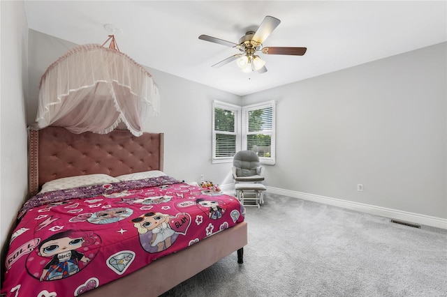 carpeted bedroom featuring baseboards, visible vents, and a ceiling fan