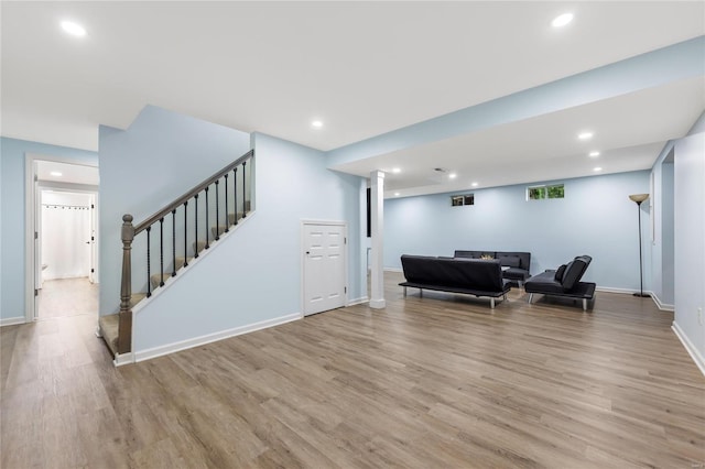 living area with light wood-style floors, recessed lighting, and stairs