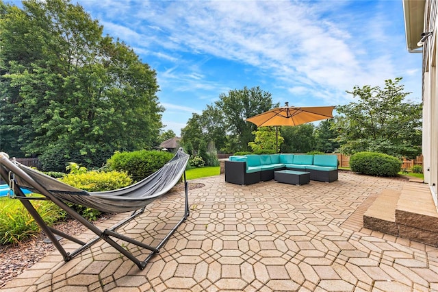 view of patio featuring fence and an outdoor hangout area