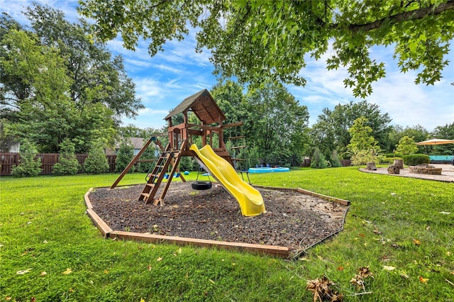 view of play area featuring fence and a lawn