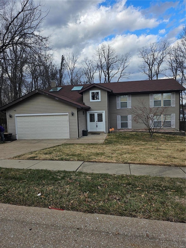 view of front of home featuring driveway, a front lawn, a chimney, and an attached garage