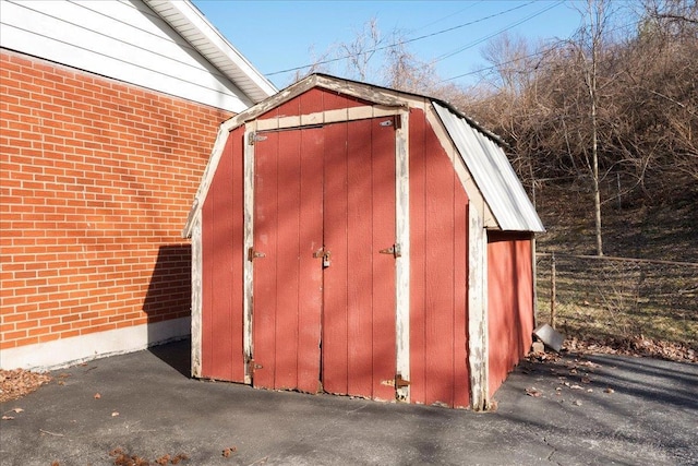 view of shed featuring fence