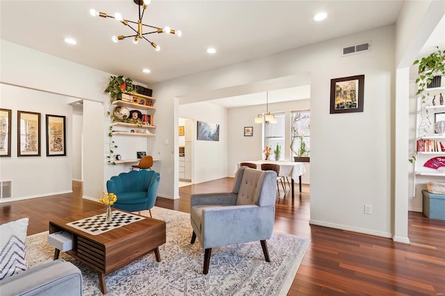 living area with recessed lighting, dark wood-style flooring, visible vents, and a notable chandelier